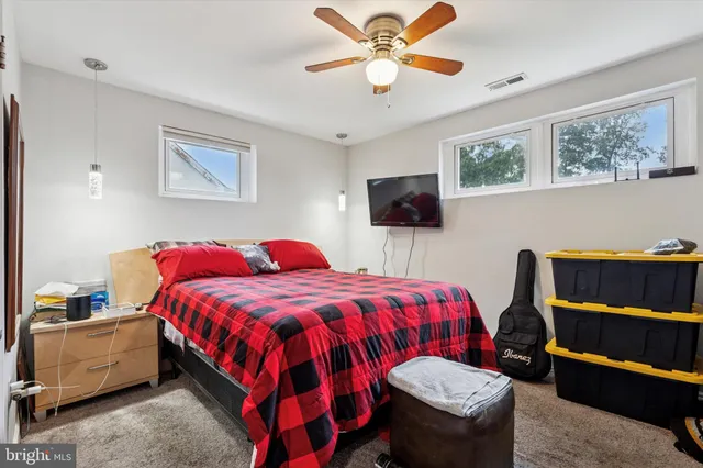 a bedroom with a bed and a television