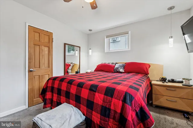 a bedroom with a bed and dresser