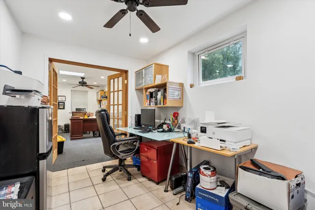 a room with stainless steel appliances kitchen island granite countertop furniture and a flat screen tv