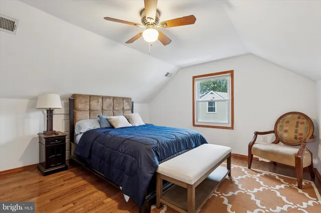 a bedroom with a bed chair and window