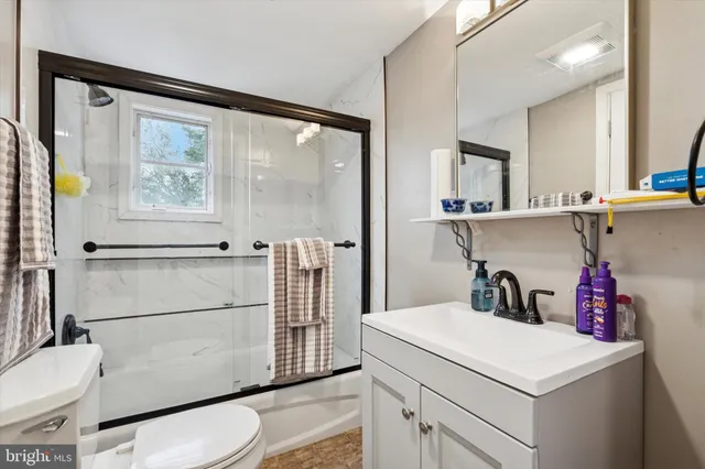 a bathroom with a sink a toilet and a shower