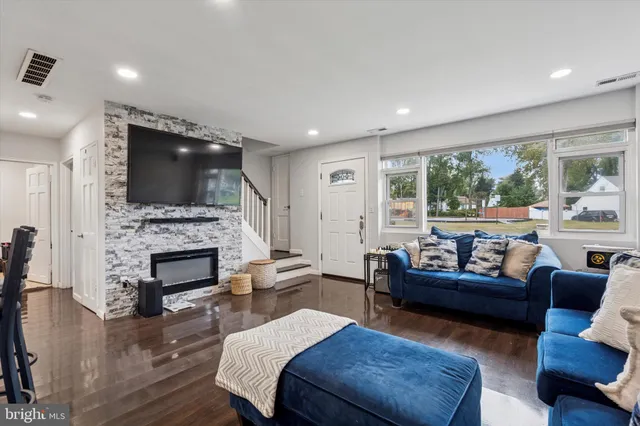 a living room with fireplace furniture and a flat screen tv