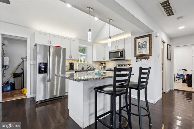 a kitchen with refrigerator and microwave