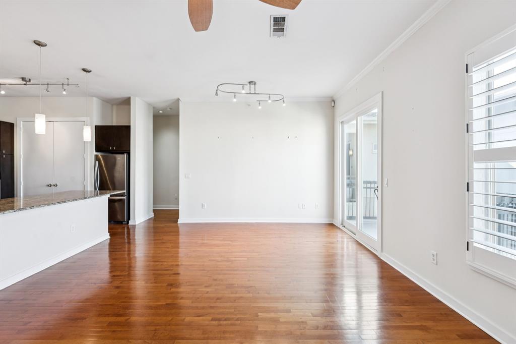 2950 McKinney Avenue, Unit 424 Dallas, TX 75204 - Photo 23 of 25 a view of an empty room with wooden floor and a window