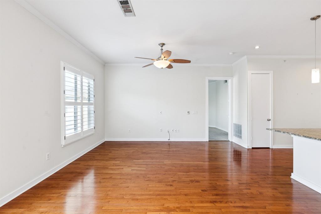 2950 McKinney Avenue, Unit 424 Dallas, TX 75204 - Photo 24 of 25 a view of an empty room with window and wooden floor