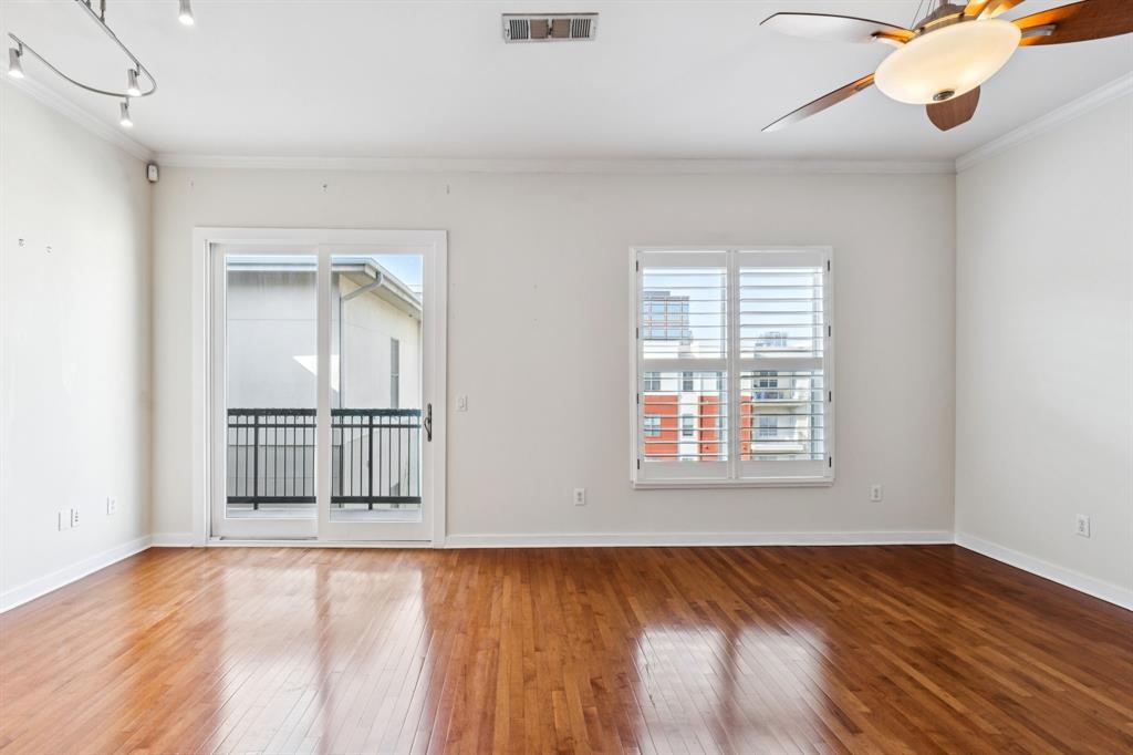 2950 McKinney Avenue, Unit 424 Dallas, TX 75204 - Photo 25 of 25 a view of an empty room with wooden floor and a window