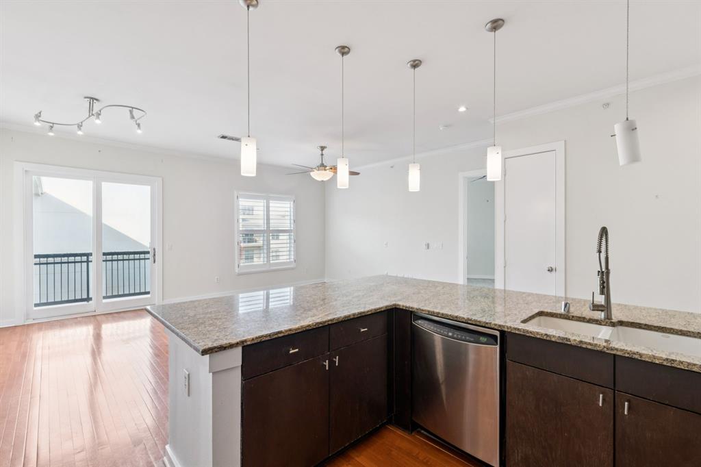 2950 McKinney Avenue, Unit 424 Dallas, TX 75204 - Photo 4 of 25 a kitchen with granite countertop a sink cabinets and window