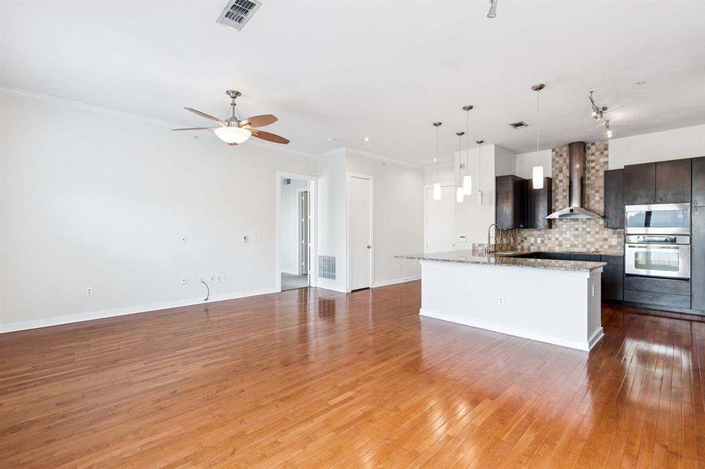 2950 McKinney Avenue, Unit 424 Dallas, TX 75204 - Photo 6 of 25 a view of kitchen with a sink dishwasher a kitchen island with wooden floors