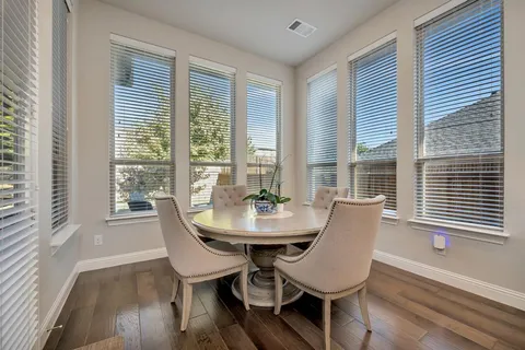 a view of a dining room with furniture and windows