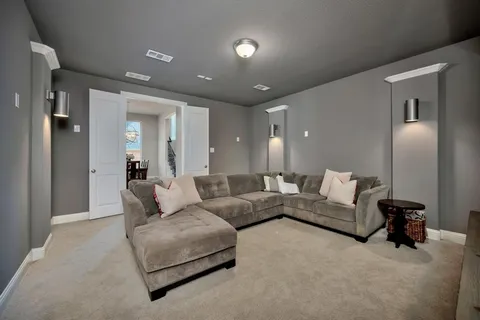 a living room with furniture and a lamp