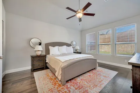 a bedroom with a large bed and a window