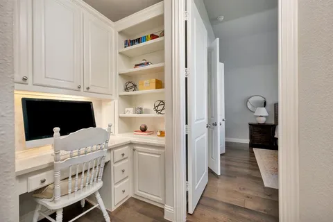 a kitchen with white cabinets and black appliances