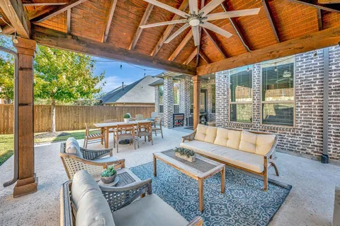 a outdoor space with patio the couches and a dining table and chairs with wooden floor