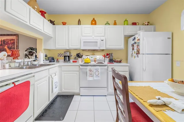 a kitchen with a refrigerator a stove a sink and cabinets