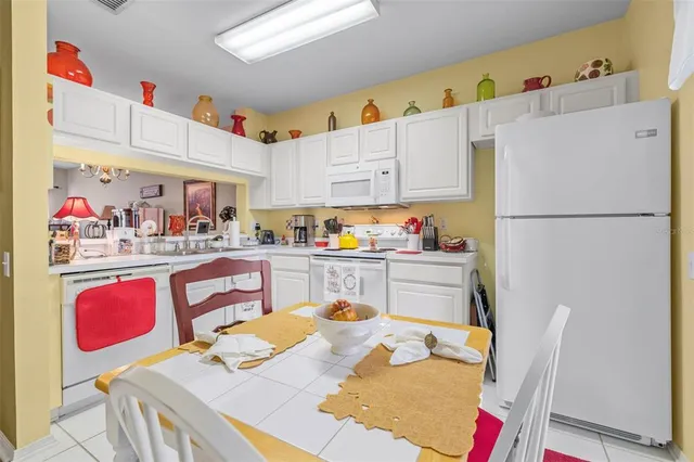 a kitchen with stainless steel appliances a refrigerator sink and cabinets