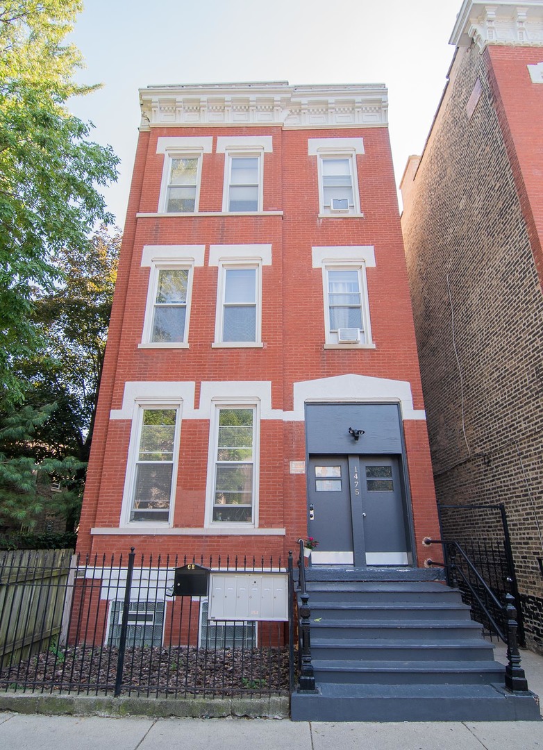 1475 West Huron Street, Unit 1R Chicago, IL 60642 - Photo 1 of 8 a front view of a multi story residential apartment building