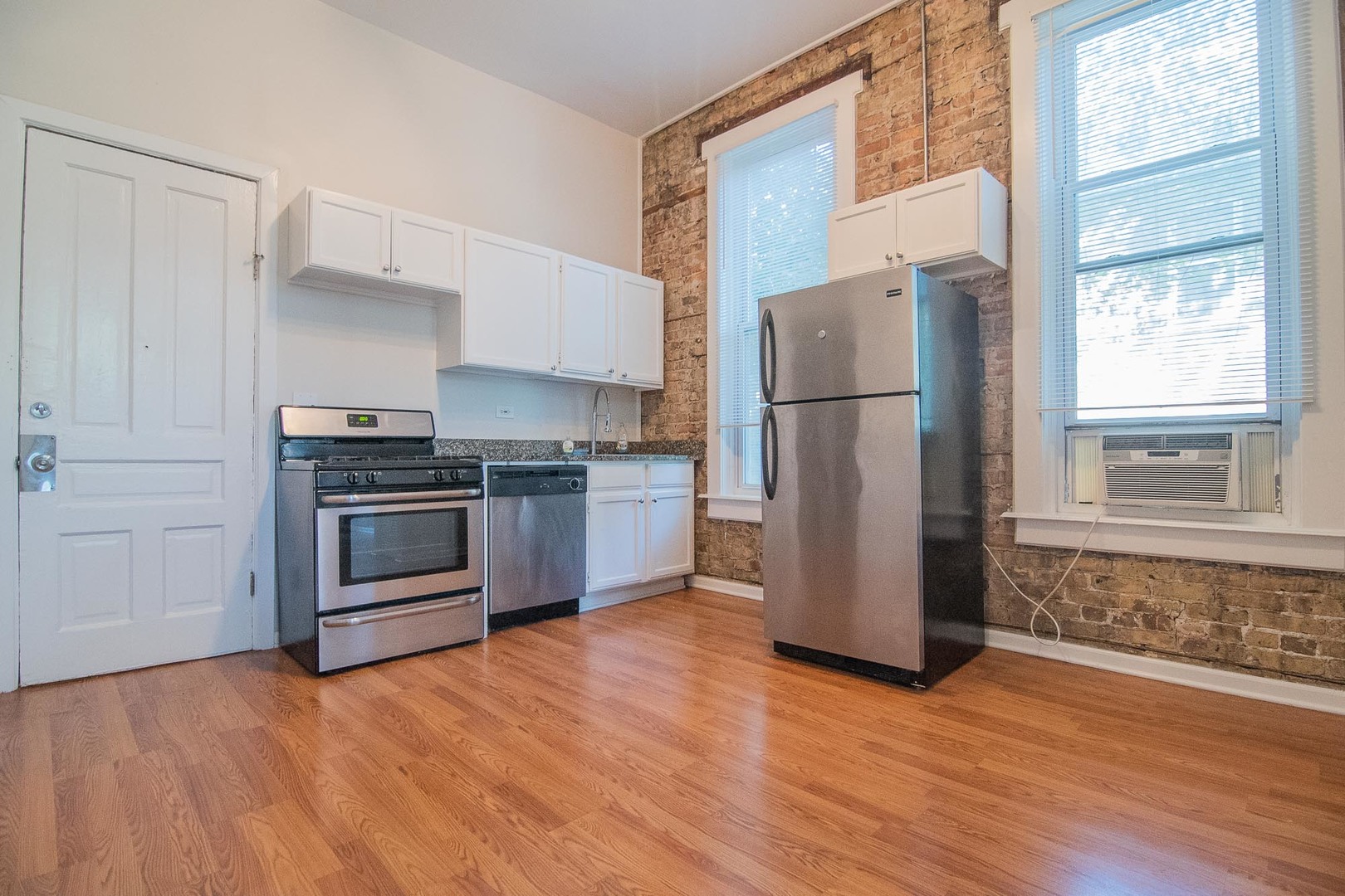 1475 West Huron Street, Unit 1R Chicago, IL 60642 - Photo 4 of 8 a kitchen with a refrigerator and a stove top oven