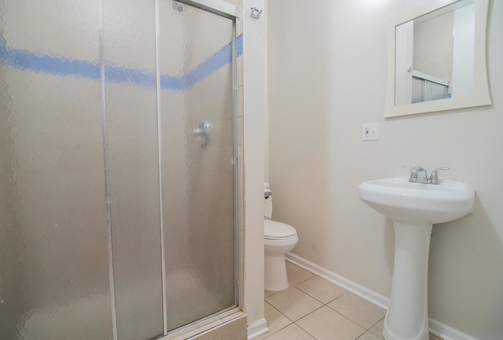 1475 West Huron Street, Unit 1R Chicago, IL 60642 - Photo 7 of 8 a bathroom with a sink toilet and shower