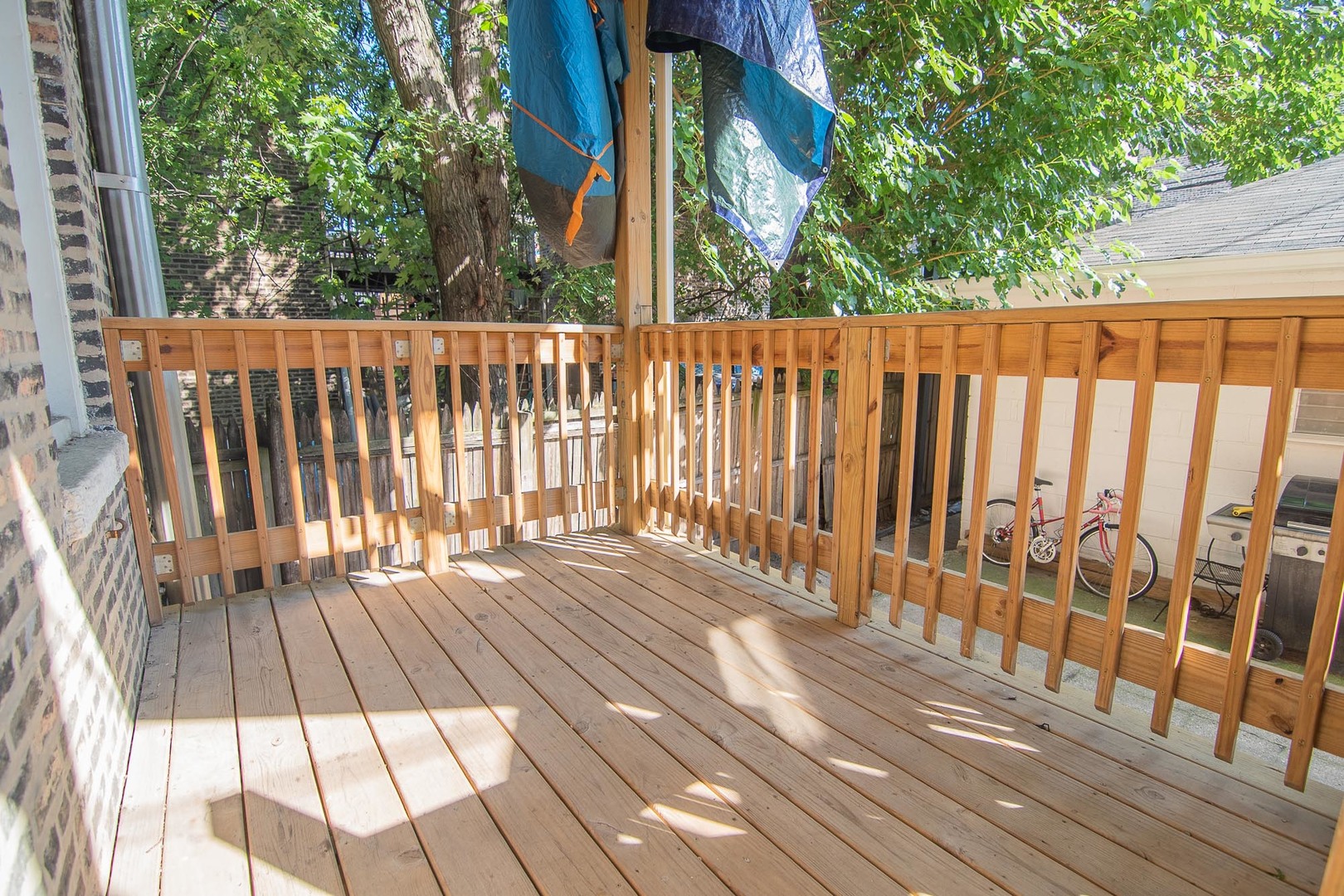 1475 West Huron Street, Unit 1R Chicago, IL 60642 - Photo 8 of 8 a view of deck with wooden floor and fence