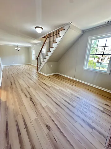 a view of entryway and hall with wooden floor