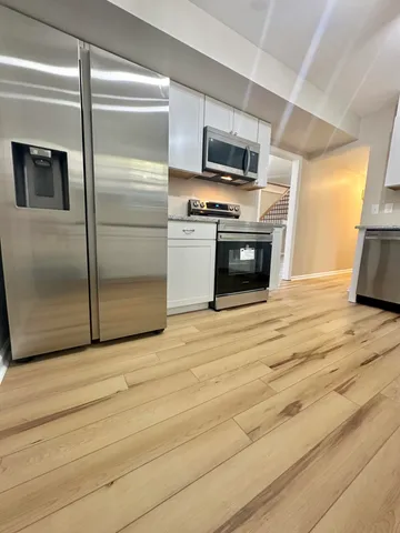 a kitchen with a refrigerator stove and microwave
