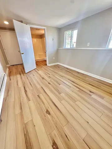 a bathroom with a toilet and a mirror