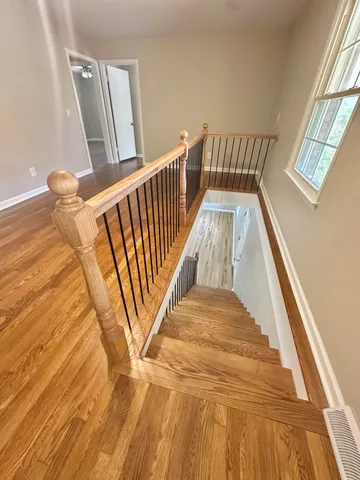 a view of a room with wooden floor