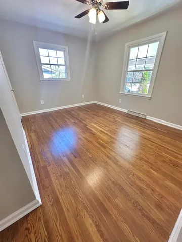wooden floor in an empty room with a window