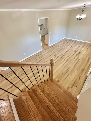 a view of a room with wooden floor