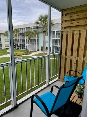 a view of a balcony with furniture