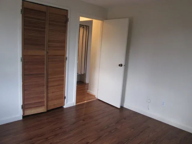 an empty room with wooden floor