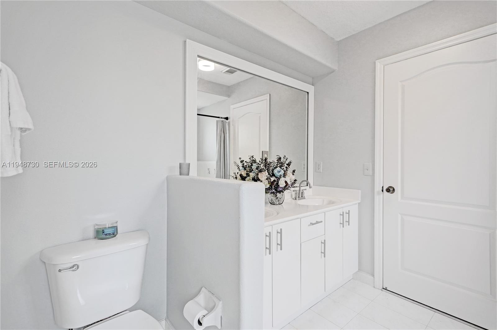 5502 Southwest 162nd Place Miami, FL 33185 - Photo 38 of 72 a bathroom with a toilet a sink and mirror