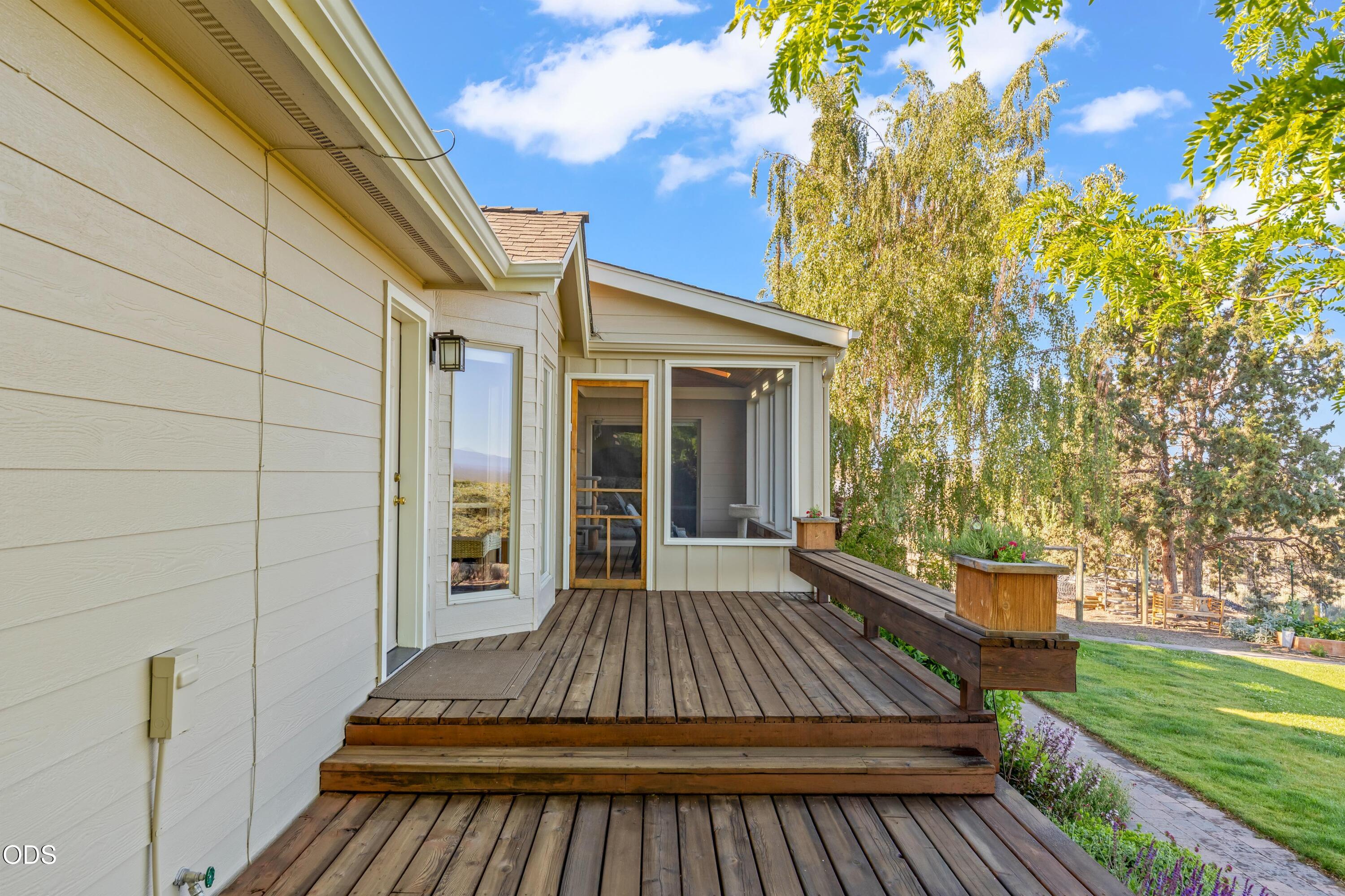 13753 South Sego Lily Road Powell Butte, OR 97753 - Photo 20 of 46 a view of backyard with deck and garden