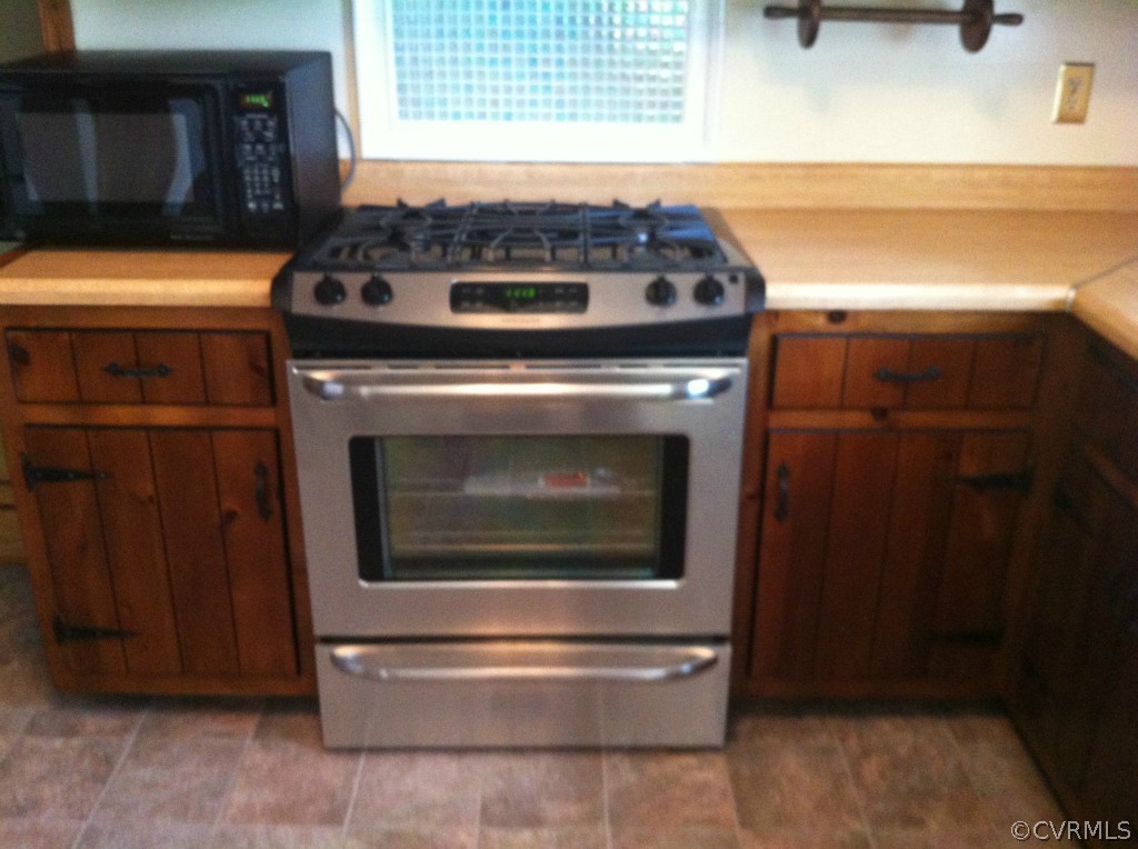 1231 Coalfield Road Midlothian, VA 23114 - Photo 3 of 12 a stove top oven sitting inside of a kitchen
