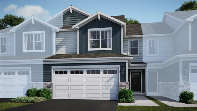 a front view of a house with a yard and potted plants