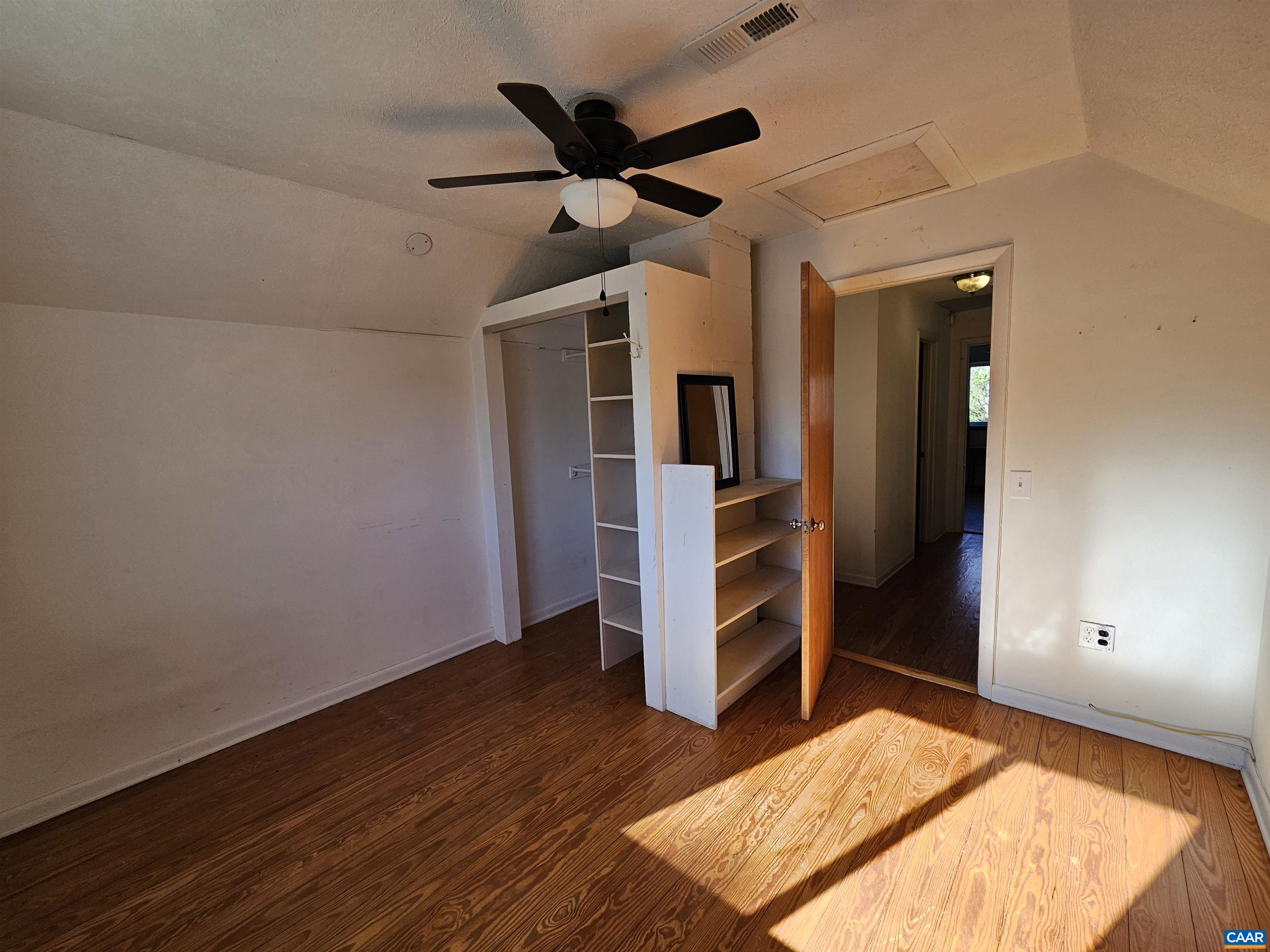 1859 Manteo Road Buckingham, VA 23921 - Photo 19 of 46 a view of a bedroom with wooden floor and a ceiling fan