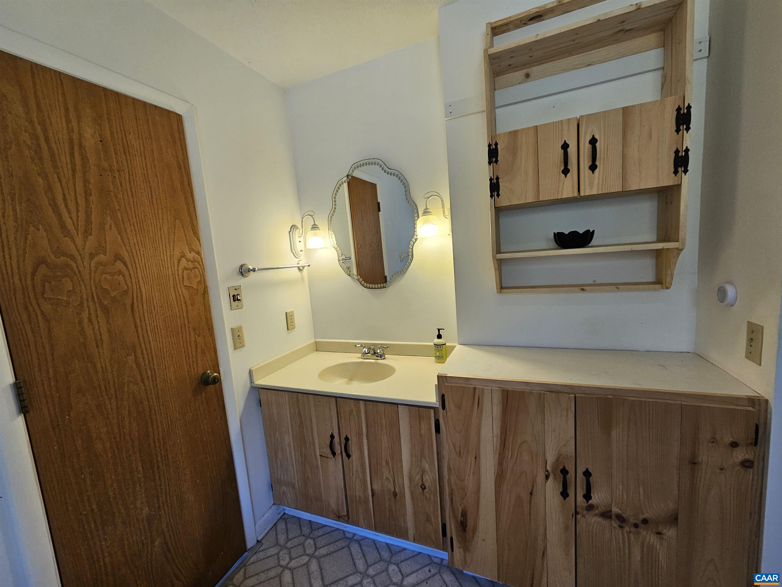 1859 Manteo Road Buckingham, VA 23921 - Photo 25 of 46 a bathroom with a sink and a mirror
