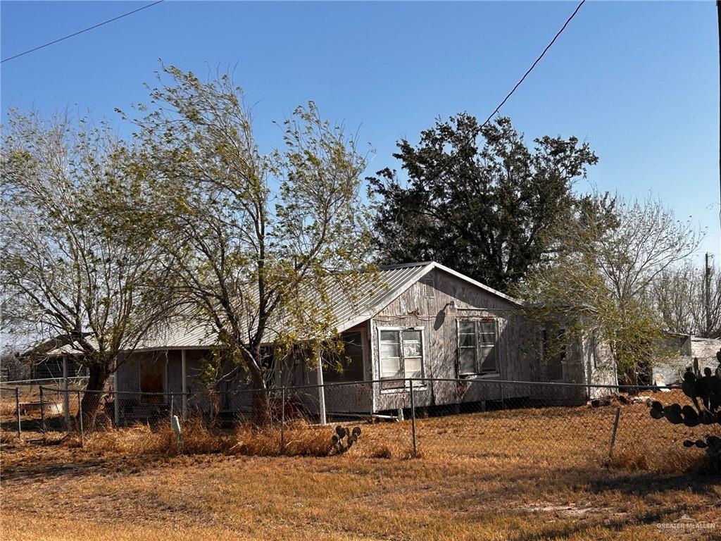 30034 Couch Street Hargill, TX 78549 - Photo 1 of 13 a front view of a house with a yard covered with snow and trees