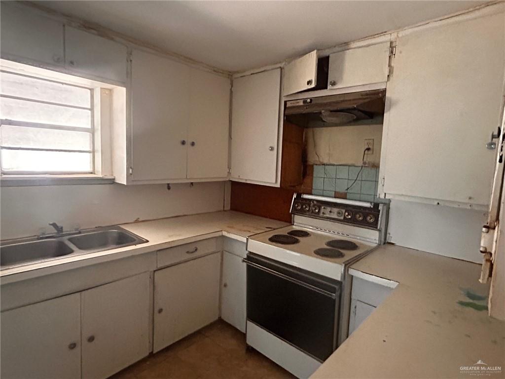 30034 Couch Street Hargill, TX 78549 - Photo 5 of 13 a kitchen with a stove and a sink