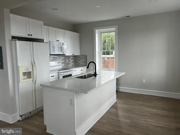 a kitchen with stainless steel appliances a sink stove and refrigerator