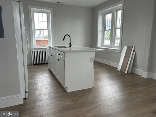 a kitchen with stainless steel appliances granite countertop a sink stove refrigerator and cabinets