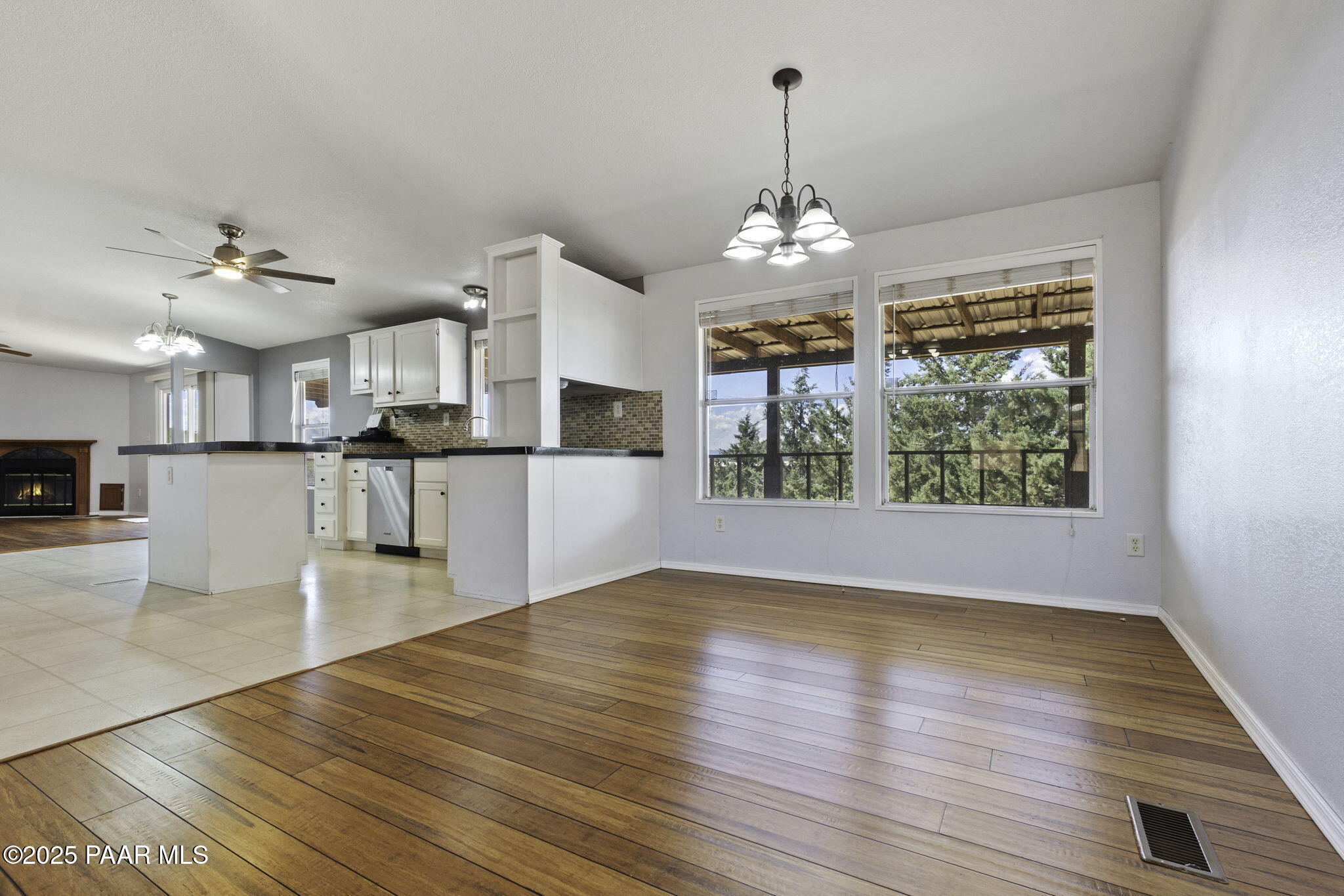 18125 East Roper Way Dewey, AZ 86327 - Photo 11 of 63 a view of a kitchen with wooden floor and a chandelier