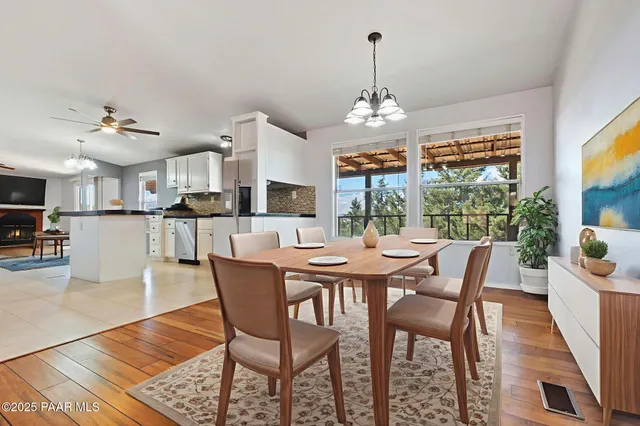 a kitchen with granite countertop a sink a counter space cabinets and stainless steel appliances