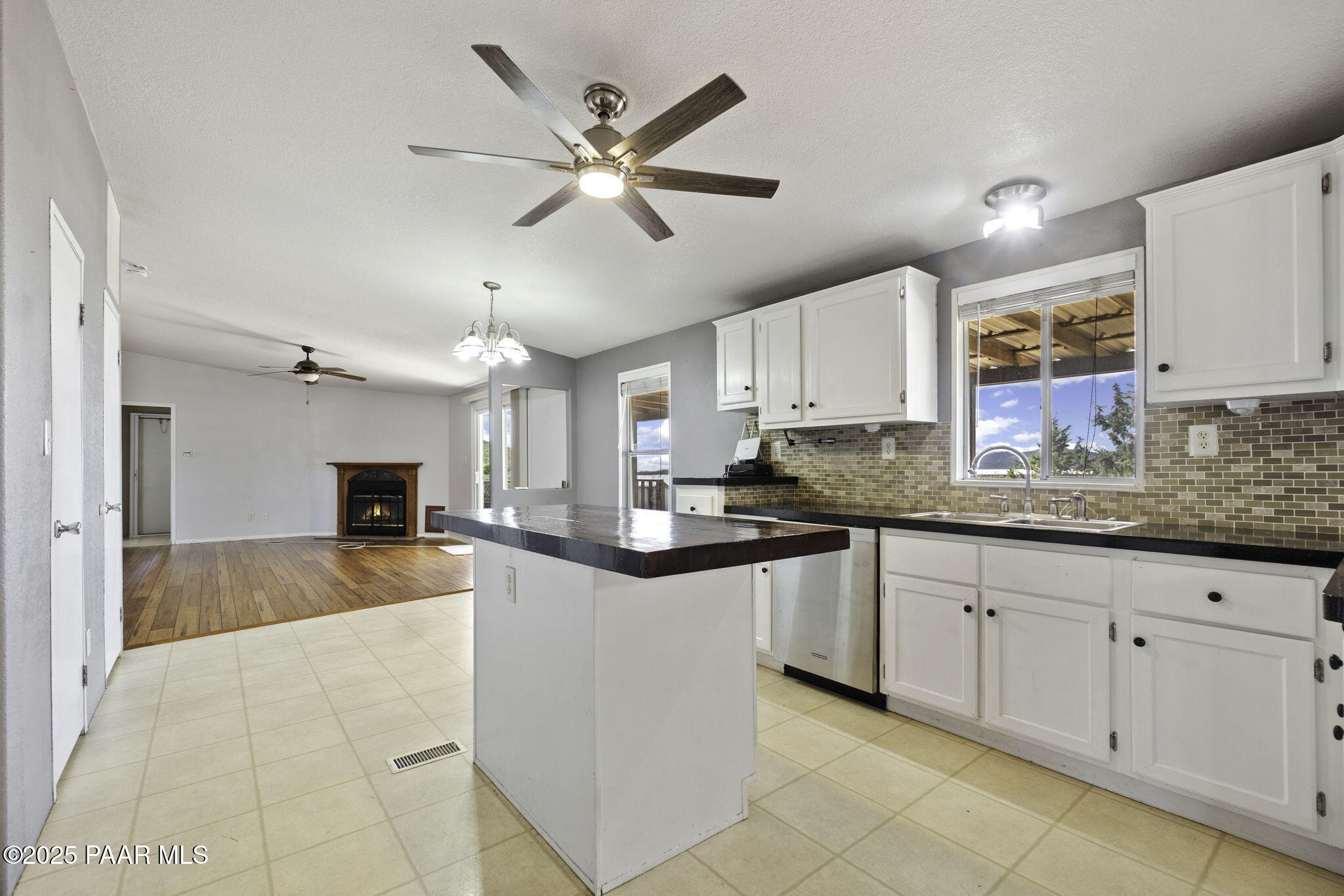 18125 East Roper Way Dewey, AZ 86327 - Photo 13 of 63 a kitchen with granite countertop a sink a counter space cabinets and stainless steel appliances