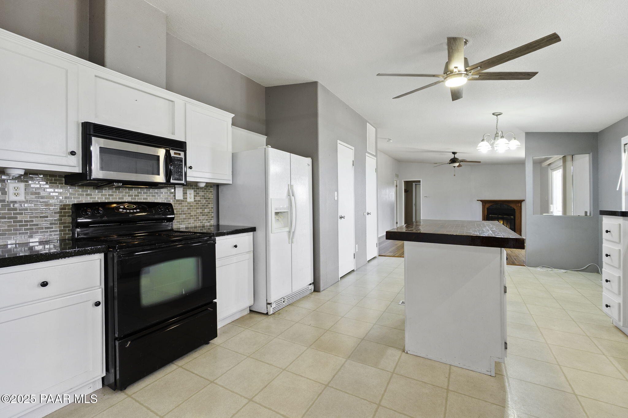 18125 East Roper Way Dewey, AZ 86327 - Photo 15 of 63 a kitchen with stainless steel appliances kitchen island granite countertop a refrigerator a stove top oven a sink and dishwasher