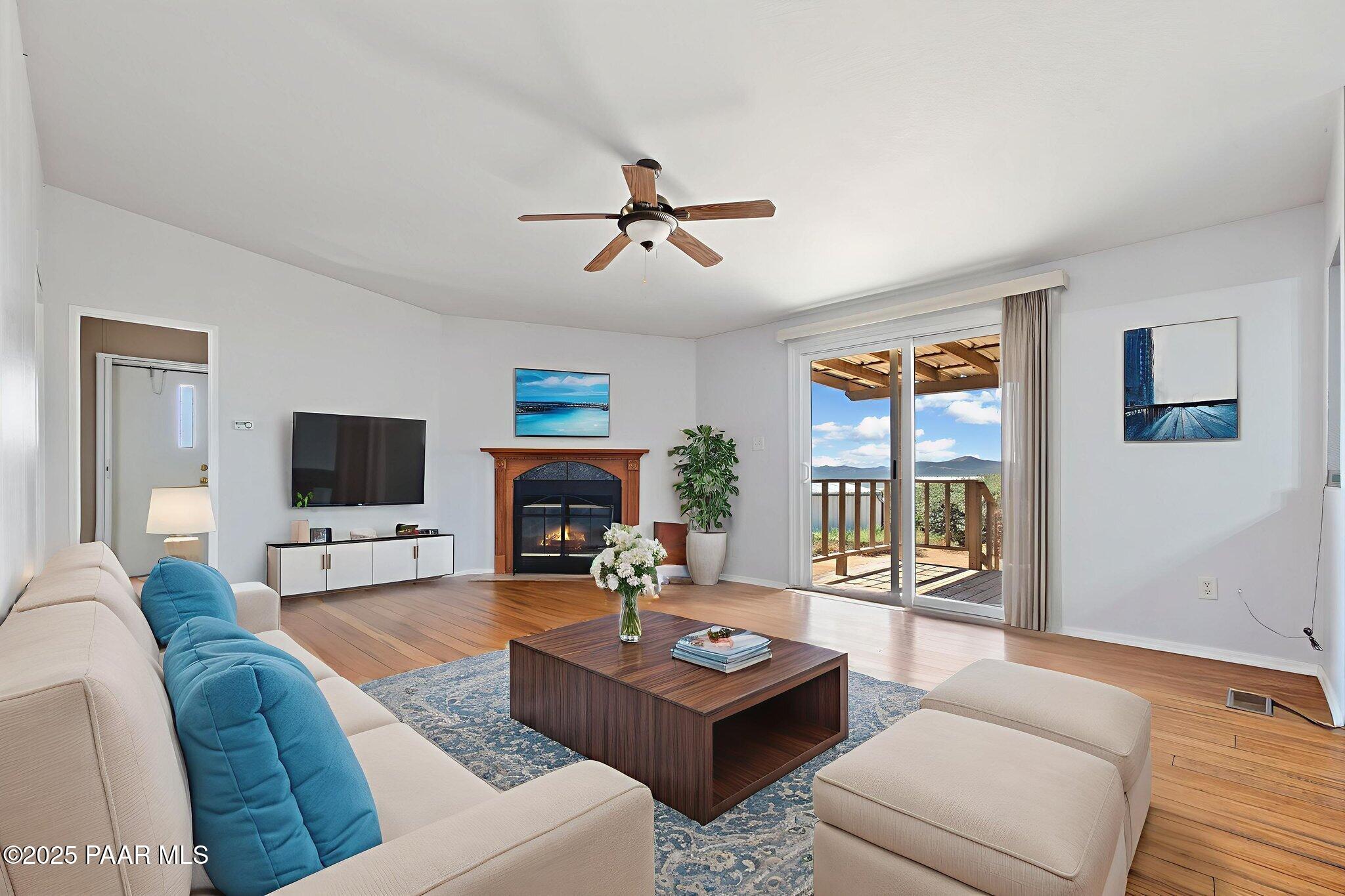 18125 East Roper Way Dewey, AZ 86327 - Photo 19 of 63 a living room with furniture a flat screen tv and a fireplace