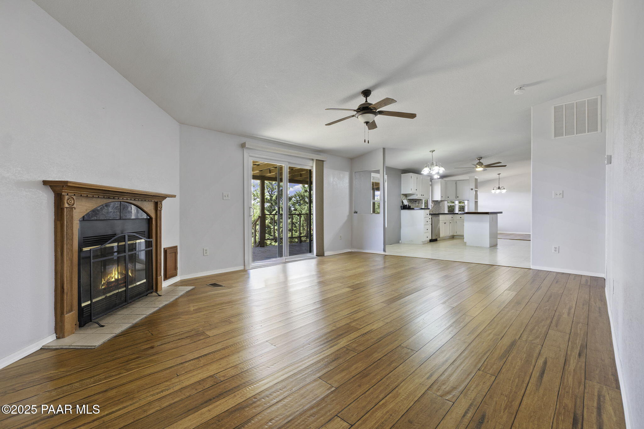 18125 East Roper Way Dewey, AZ 86327 - Photo 20 of 63 a view of empty room with a fireplace and wooden floor