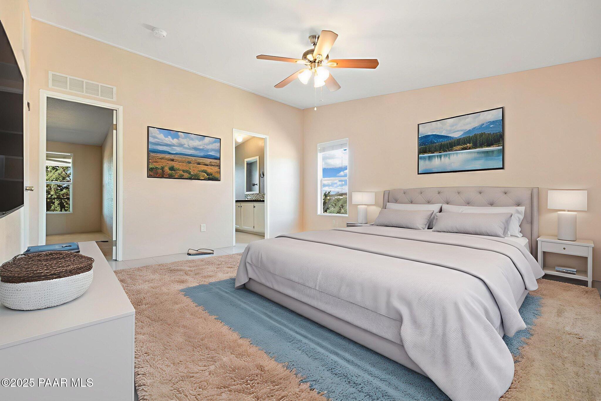 18125 East Roper Way Dewey, AZ 86327 - Photo 23 of 63 a bedroom with a bed and a chandelier