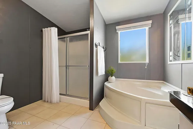 an empty room with closet and a ceiling fan