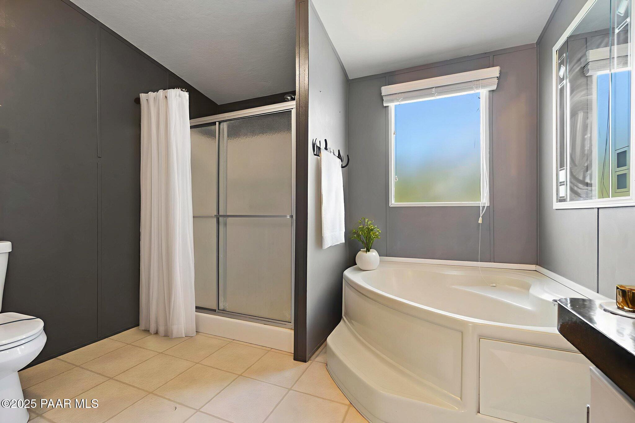 18125 East Roper Way Dewey, AZ 86327 - Photo 29 of 63 a bathroom with a bathtub and a shower